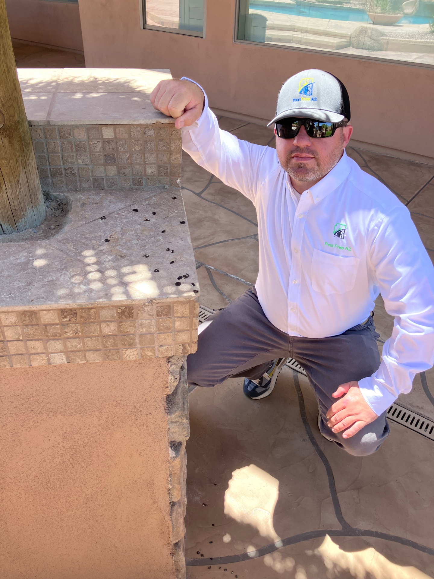 Matt from Pest Free AZ inspecting scorpion activity on a Mesa patio wall